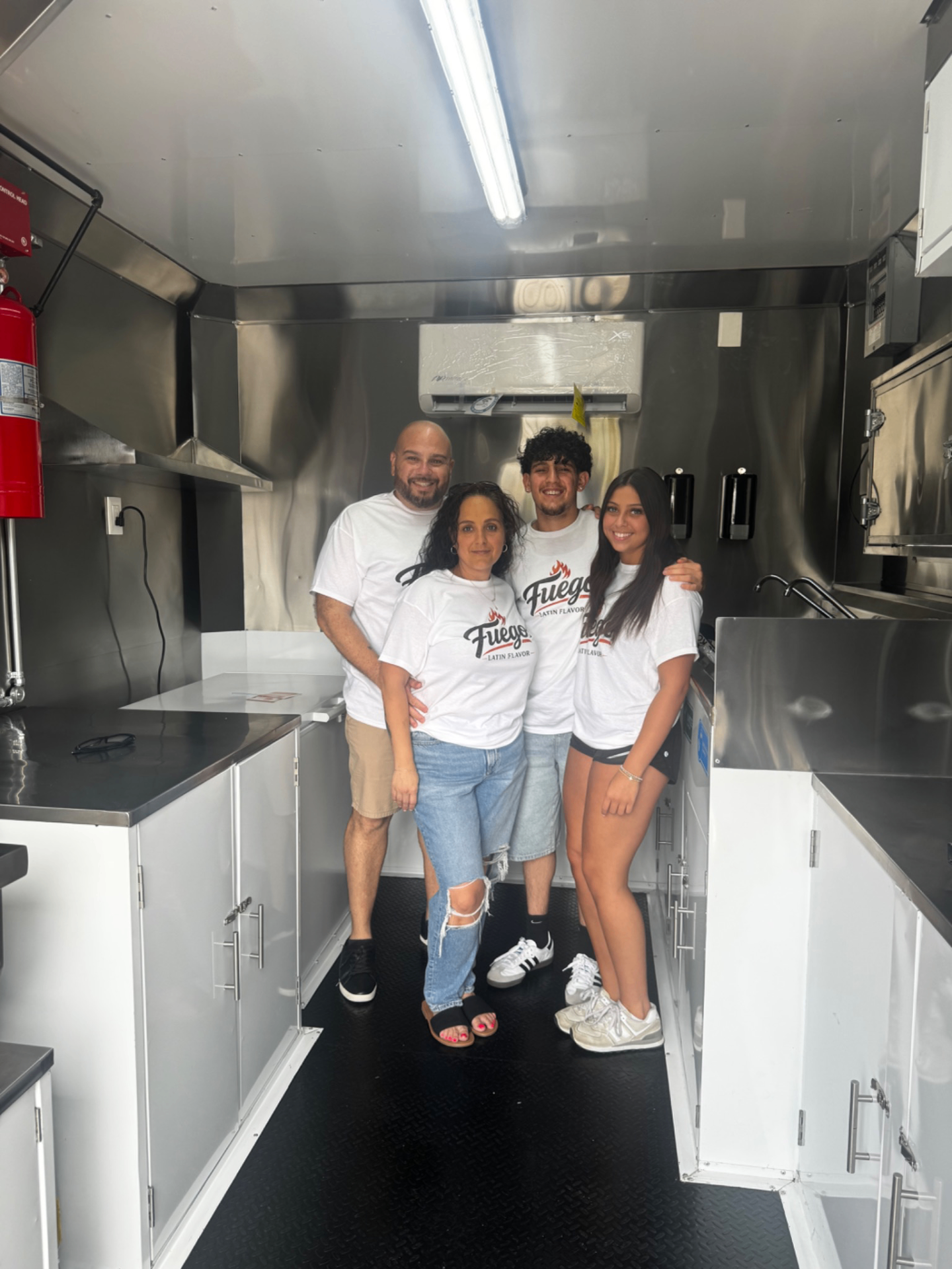 The Mercado family inside the Fuego Latin Flavor food trailer